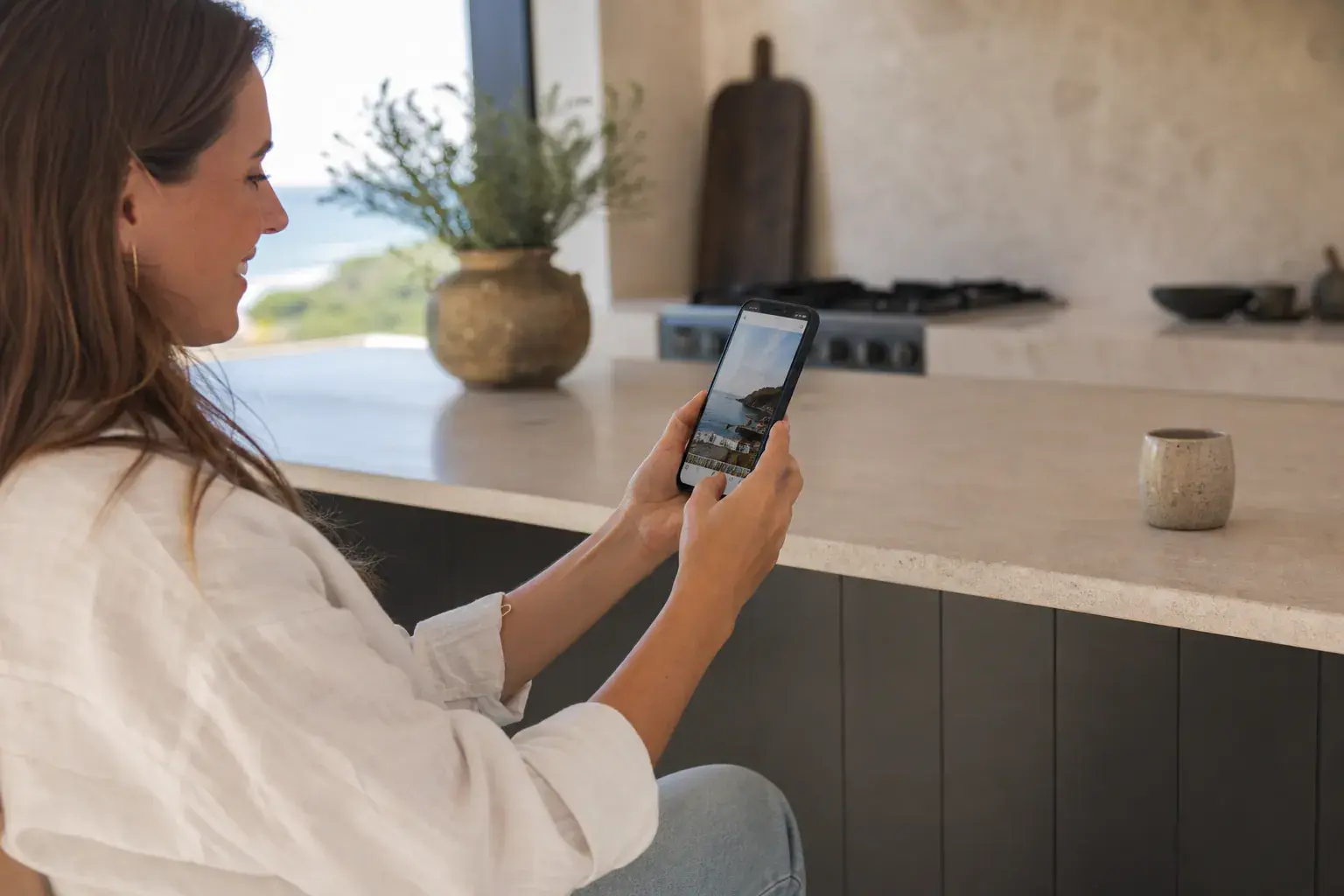 A guest using a phone where a vacation-rental guestbook no longer needs a pen